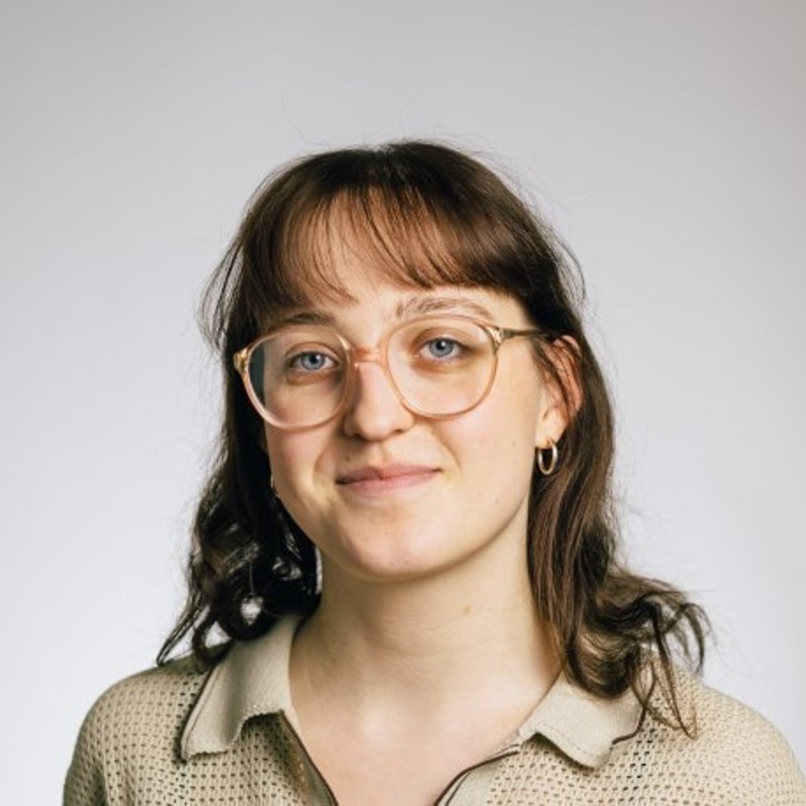 Portrait einer Frau mit Brille vor hellgrauem Hintergrund