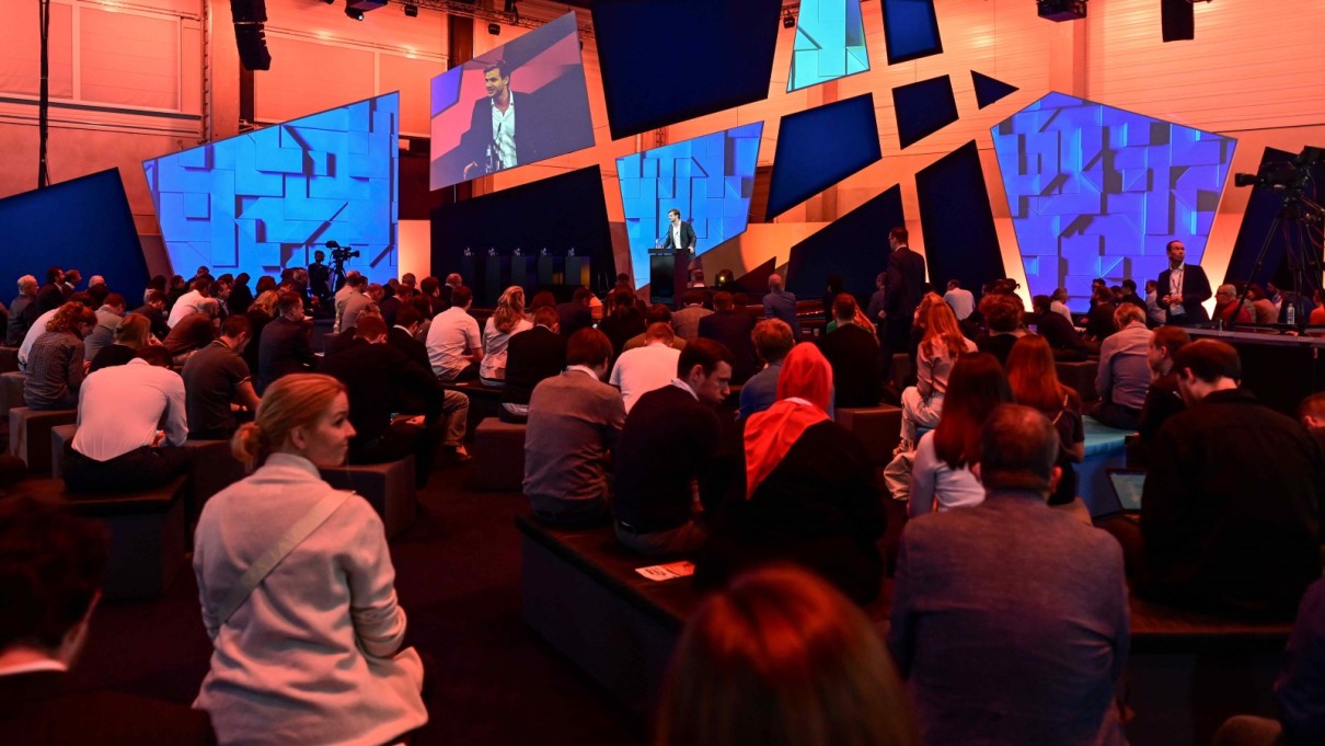 Man on the SCCON stage, audience in the foreground. 