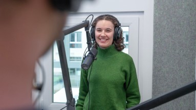 Young woman with headphones at the microphone