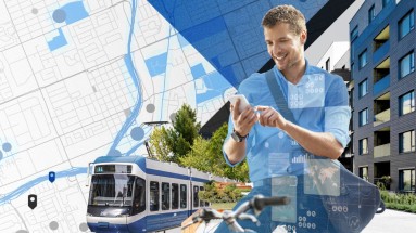 Das Bild zeigt eine Tram und einen Mann auf einem Fahrrad, der auf seinem Smartphone die eingezeichnete Fahrtstrecke verfolgt.