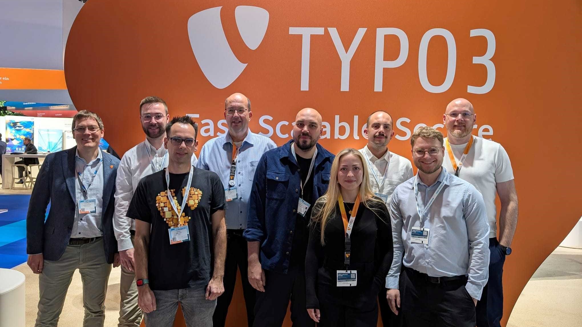 The TYPO3 stand at the Smart Country Convention 2024, with several people in front of it.